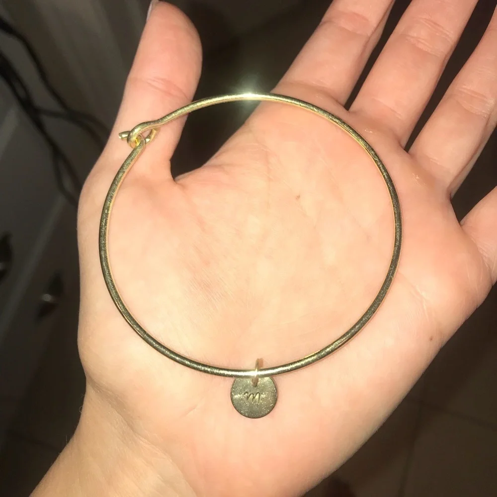 Gold bracelet with M charm